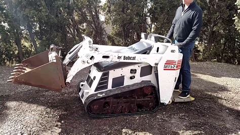 bobcat stand behind skid steer